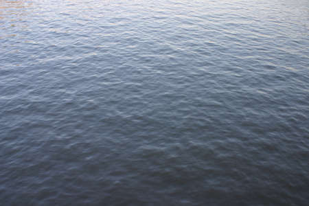 The surface texture of water, covered with small ripplesの写真素材
