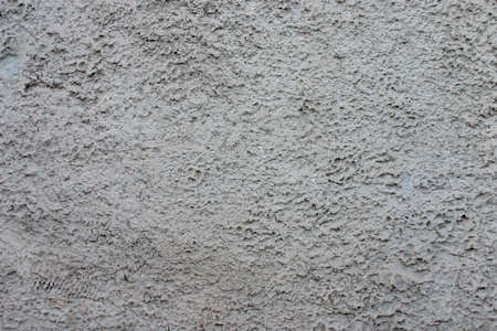 texture of gray rough plaster on the wall surfaceの写真素材