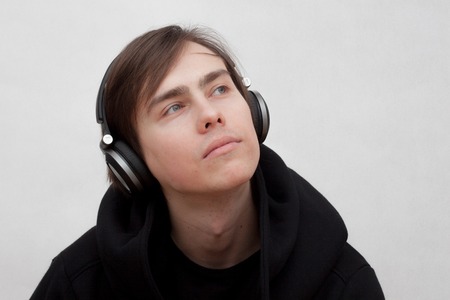 white young man listening to music on headphonesの写真素材