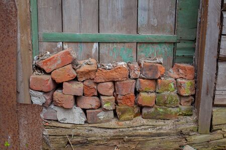 a pile of broken red bricks on the doorstepの写真素材
