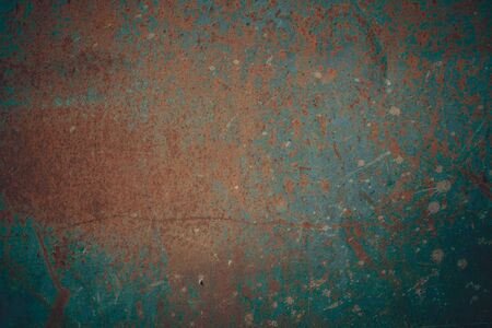 Rusty metal surface covered with cracked paint