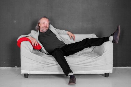 White man with beard on the couchの写真素材