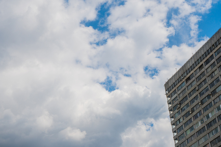 Modern high-rise building made of glass against the skyの写真素材
