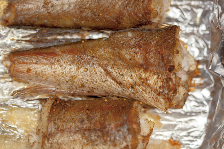 Fried fish pieces on food foil