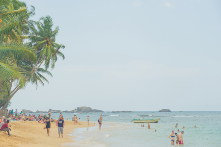 Palm trees, yellow sand and blue ocean in Sri Lanka.のeditorial素材