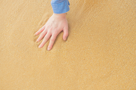 Texture of yellow sand with a trace from the hand of man.の写真素材