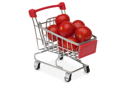 Red tomatoes in a supermarket cartの写真素材