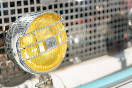 Yellow, chrome headlight retro car.の写真素材