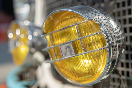 Yellow, chrome headlight retro car.の写真素材