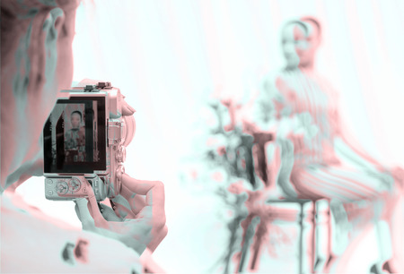 Female hands hold the camera. The model is posing. Double exposure.の写真素材