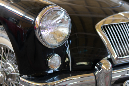 The headlight of an antique, rarity, vintage black car.の写真素材
