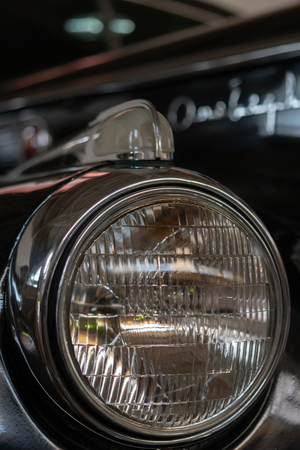 The headlight of an antique, rarity, vintage black car.の写真素材