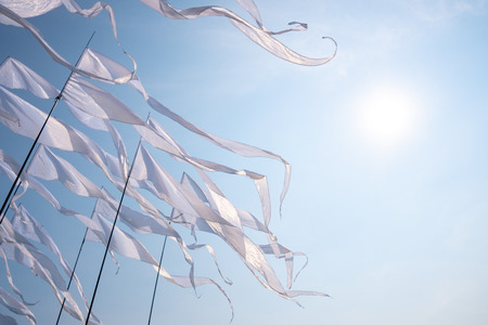 Triangular white banner against the blue sky.の写真素材