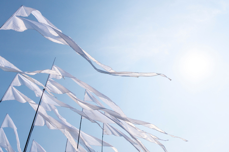 Triangular white banner against the blue sky.の写真素材