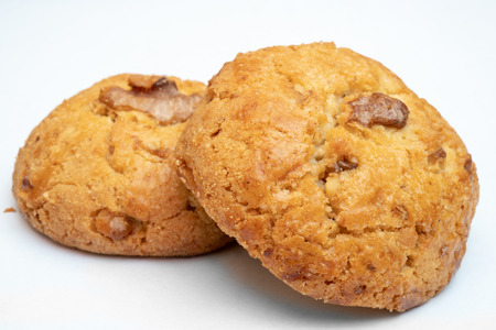 Fresh, tasty, round cookies with walnuts on a white background.の写真素材