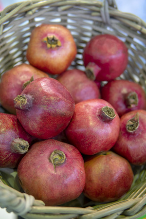 Red, ripe pomegranates in the basket.の写真素材