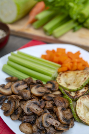 Vegan diet food. Fried mushrooms with celery, carrots and zucchini.の写真素材