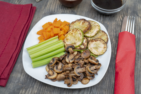 Vegan diet food. Fried mushrooms with celery, carrots and zucchini.の写真素材