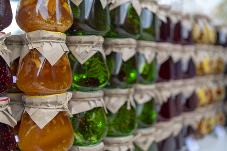 Multicolored fruit and berry jam in glass jars.の写真素材