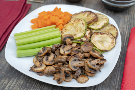Vegan diet food. Fried mushrooms with celery, carrots and zucchini.の写真素材