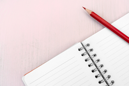 Red pencil and notebook for notes.の写真素材