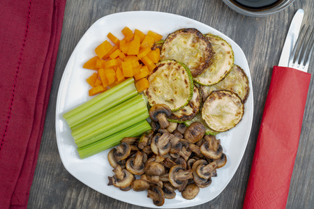 Vegan diet food. Fried mushrooms with celery, carrots and zucchini.の写真素材