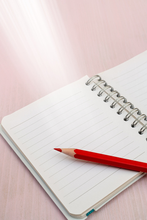 Red pencil and notebook for notes.の写真素材