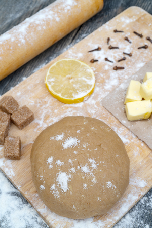 on the kitchen table. Ingredients - butter, lemon, flour, sugar, cloves.の写真素材