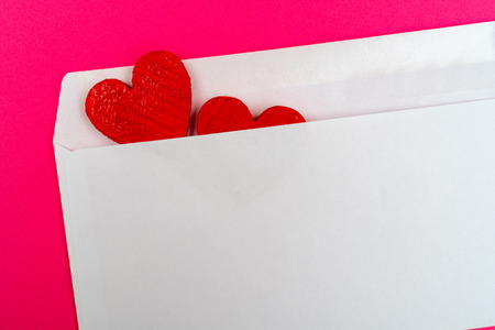 Two red hearts in a white envelope.の写真素材