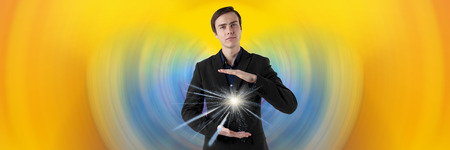 Young scientist on a futuristic background. Energy in the hands. Insight.の写真素材