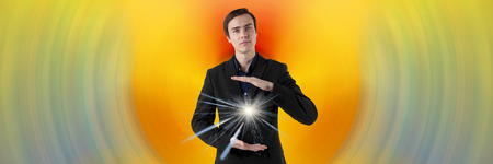 Young scientist on a futuristic background. Energy in the hands. Insight.の写真素材