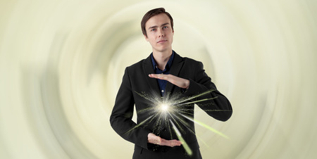 Young scientist on a futuristic background. Energy in the hands. Insight.の写真素材