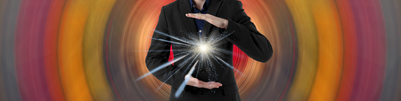 Young scientist on a futuristic background. Energy in the hands. Insight.の写真素材