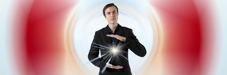 Young scientist on a futuristic background. Energy in the hands. Insight.の写真素材