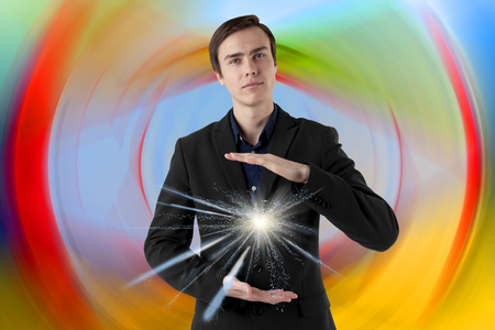 Young scientist on a futuristic background. Energy in the hands. Insight.の写真素材