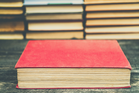 Old book in the red obnozhka. Symbol of knowledge and learning.の写真素材