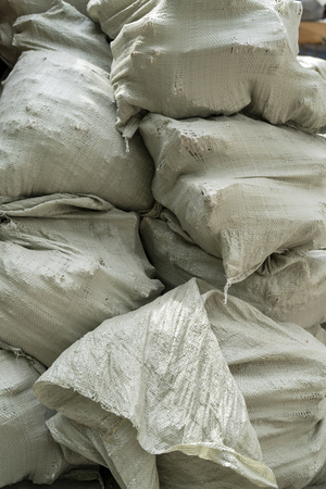 Gray bags of garbage at the dump.の写真素材