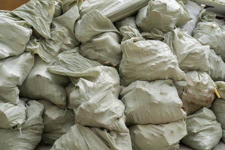Gray bags of garbage at the dump.の写真素材