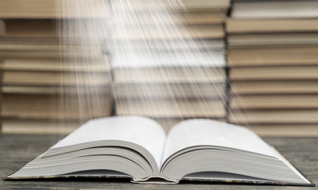 Book pages emit light. Symbol of wisdom, knowledge and learning.の写真素材