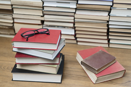 Glasses on the background of books. Symbol of knowledge, science, study, wisdom.の写真素材