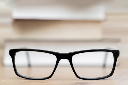 Glasses on the background of books. Symbol of knowledge, science, study, wisdom.の写真素材