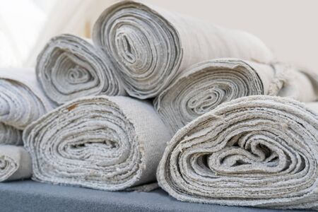 Rolls of white linen fabric handmade.の写真素材