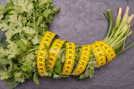 Measuring tape for measuring the circumference. Vegetables for diet cooking.の写真素材