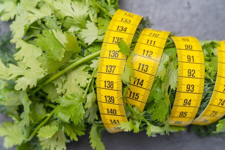 Measuring tape for measuring the circumference. Vegetables for diet cooking.の写真素材
