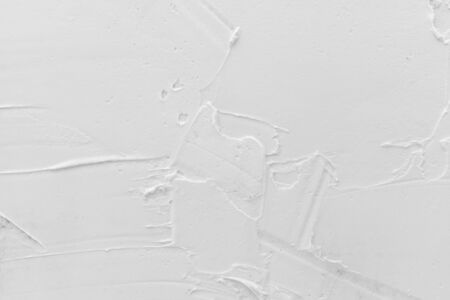 Texture of white plaster. Covering the concrete wall of the house. Rough surface. Repair and construction.の写真素材