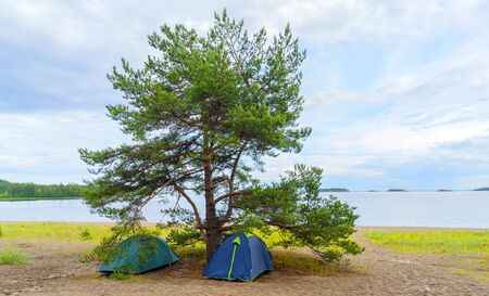 Tents on the sandy shore of the lake.の写真素材