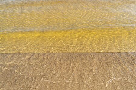 Transparent water of the lake on sandy shallow water.の写真素材
