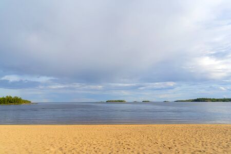Sandy beach on the shore of a clean lake.の写真素材