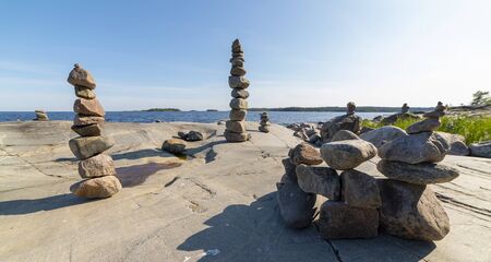 Stacked Rocks balancing, stacking with precision. Stone tower on the shore. Copy space.の写真素材