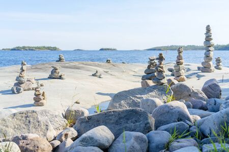 Stacked Rocks balancing, stacking with precision. Stone tower on the shore. Copy space.の写真素材